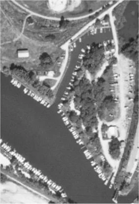 Black-and-white aerial photograph of the FHYC grounds on the point between the Grand River and Lake Erie