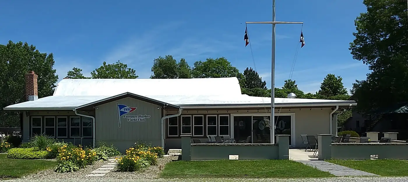 The FHYC clubhouse exterior on a sunny day with its flagpole mast