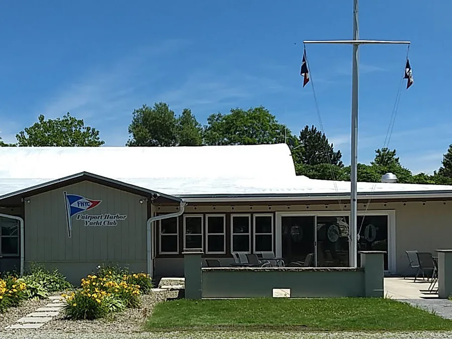 The FHYC clubhouse on a summer day, with its flagpole mast and flower beds
