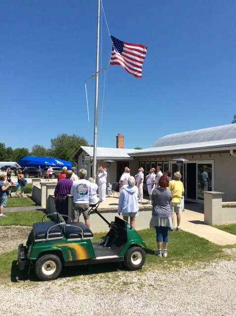 Members gathered for the Memorial Day flag raising at the clubhouse mast