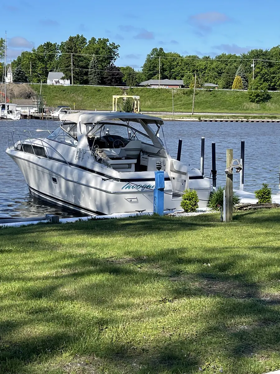 A powerboat tied up at a grassy slip on the Grand River