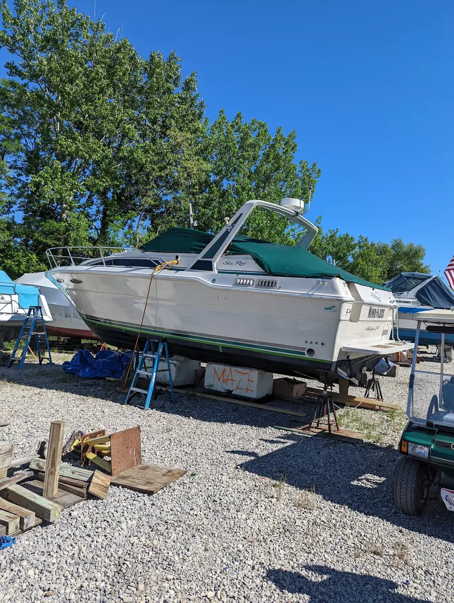 A powerboat resting on stands in the winter storage yard