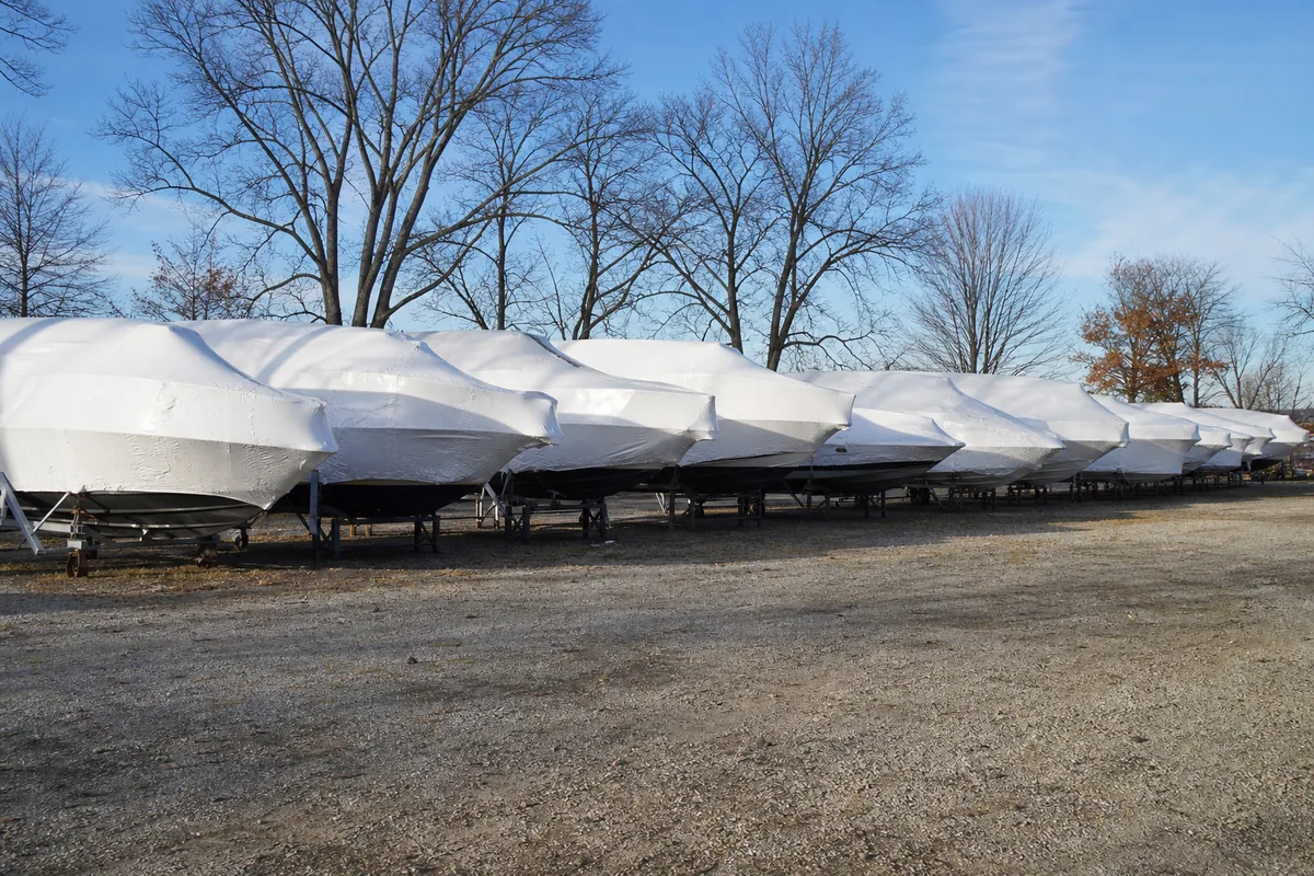 Rows of shrink-wrapped boats on cradles in late-autumn light